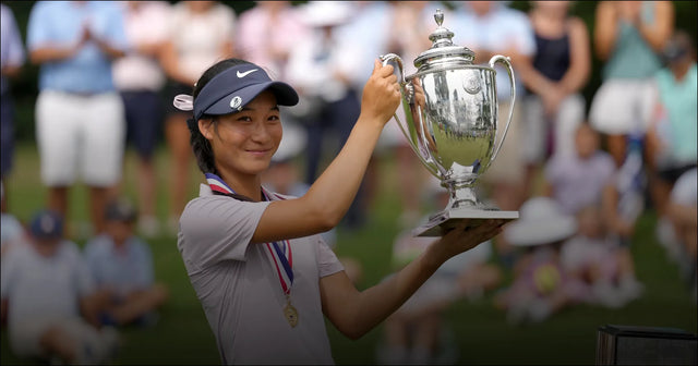 A young golfer raising the championship cup.