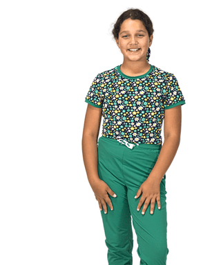 Unstoppable Tee Green Garden — Girls' Golf Tee, front view, full length on model